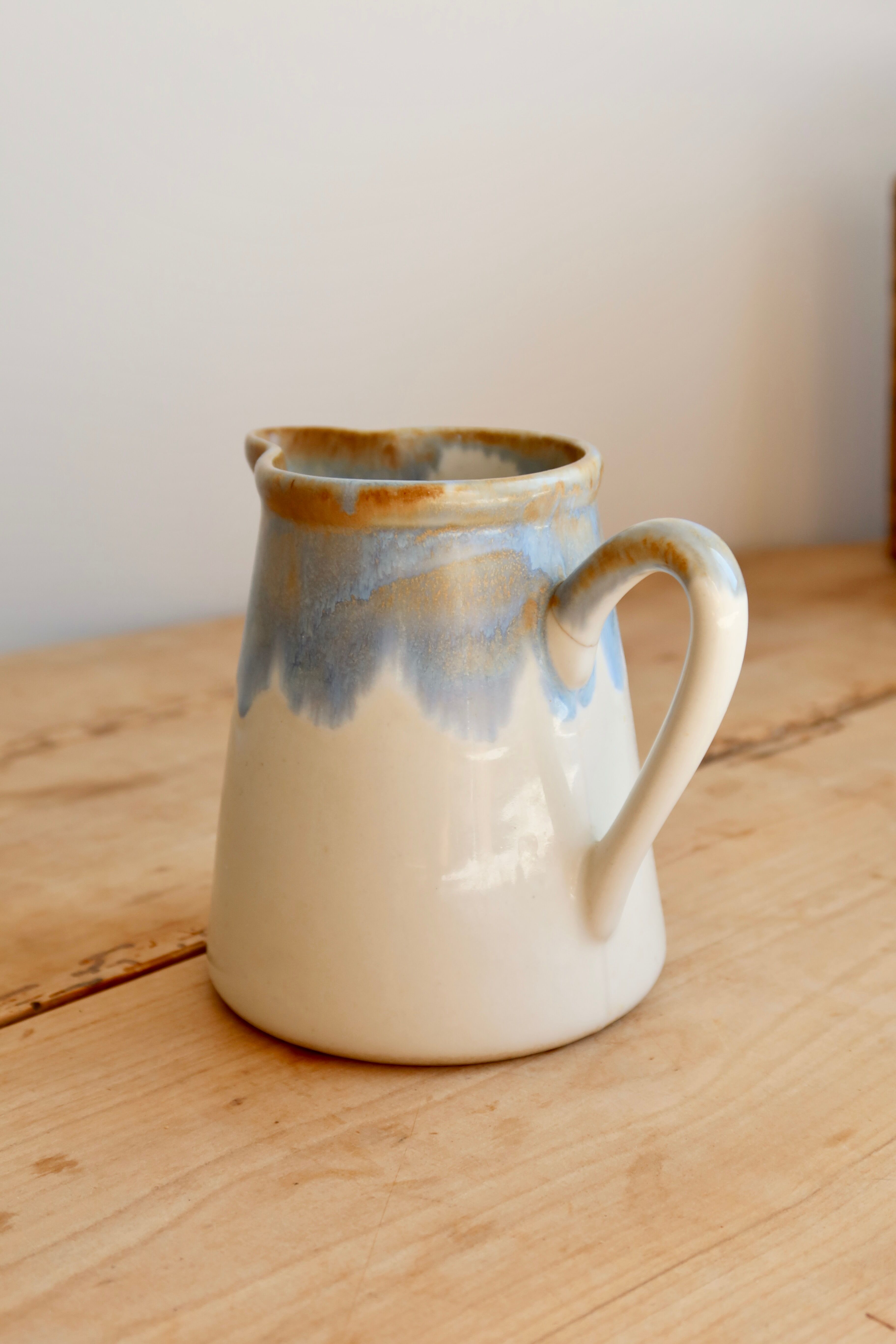 Vintage ceramic milk jug with a blue and taupe gradient glaze.