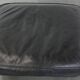 Set of a black cowhide leather Chesterfield armchair and matching ottoman