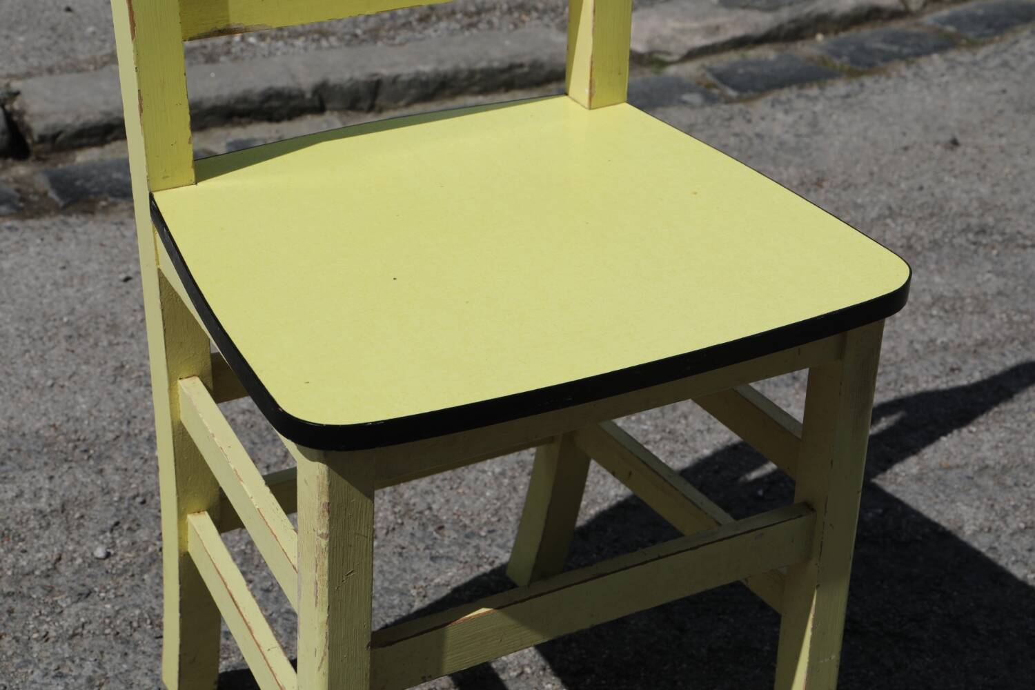 Formica and yellow wood chair