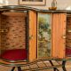 Vintage bar on wheels with tambour doors and painted decor – 1950s.
