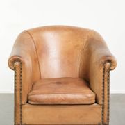 Comfortable sheepskin club armchair in a cognac colour