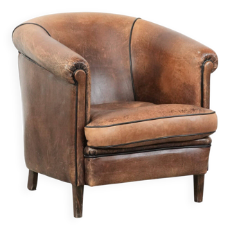 Vintage sturdy sheepskin club armchair with a beautiful patina