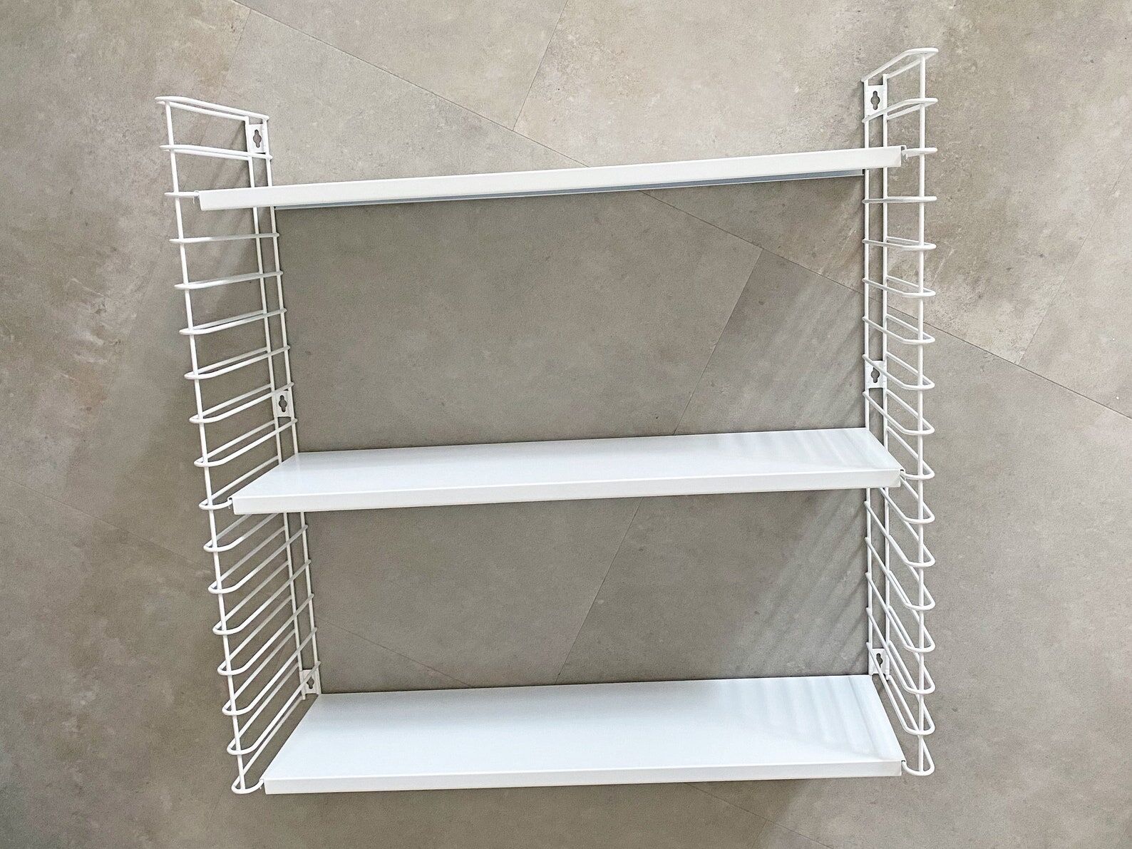 Tomado wall shelves designed by D. Dekker for TOMADO