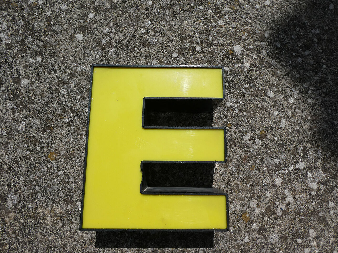 Yellow and black industrial sign letter "E"