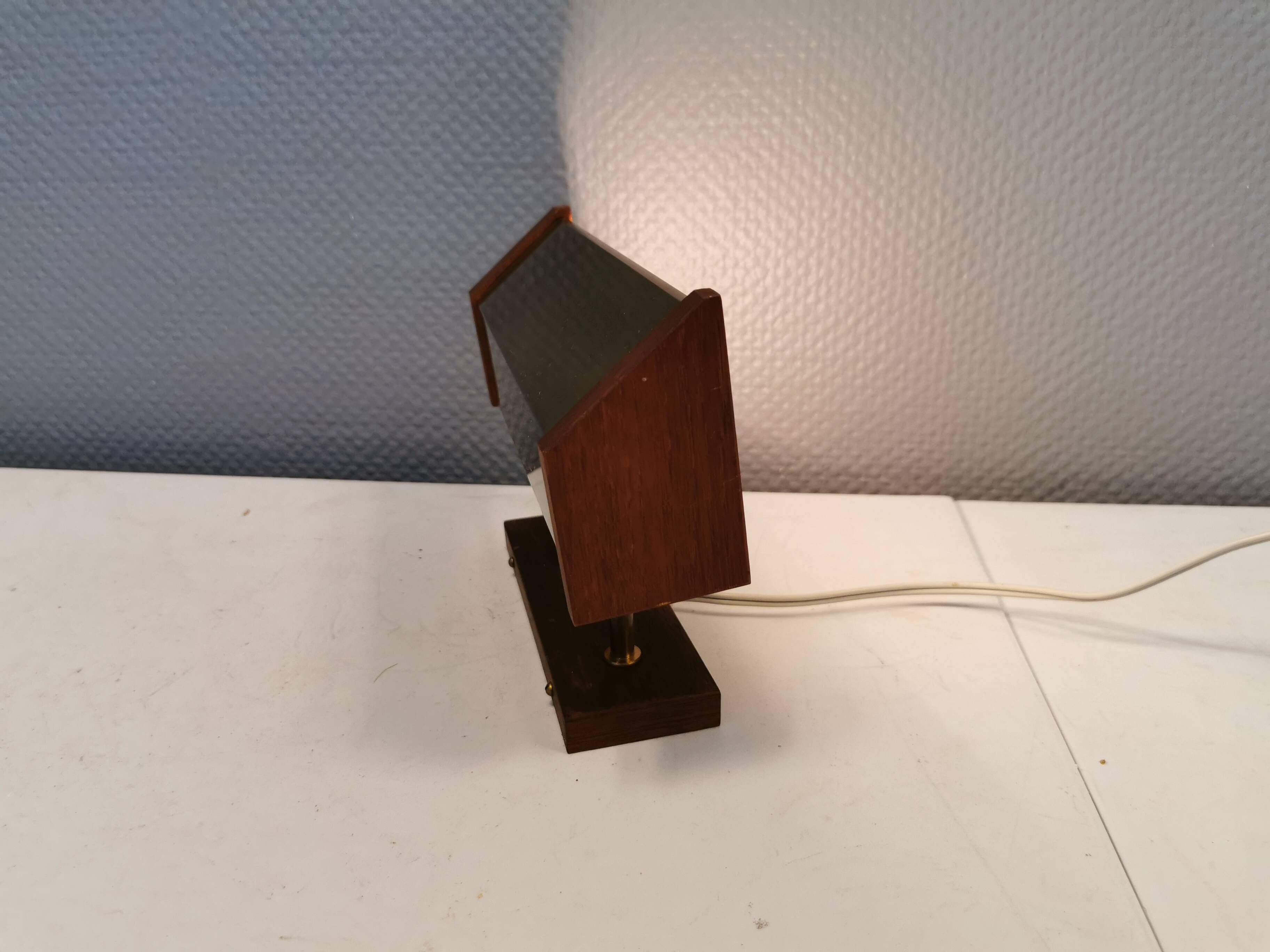 Fuga wall lamp in solid brass and teak wood was designed by Jo Hammerborg for Fog & Mørup in 1966.