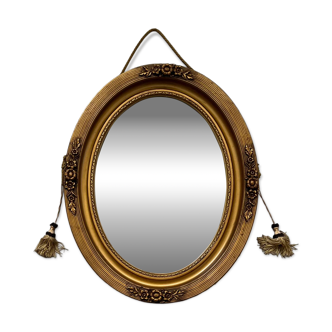 Miroir ovale doré et passementerie Art Déco