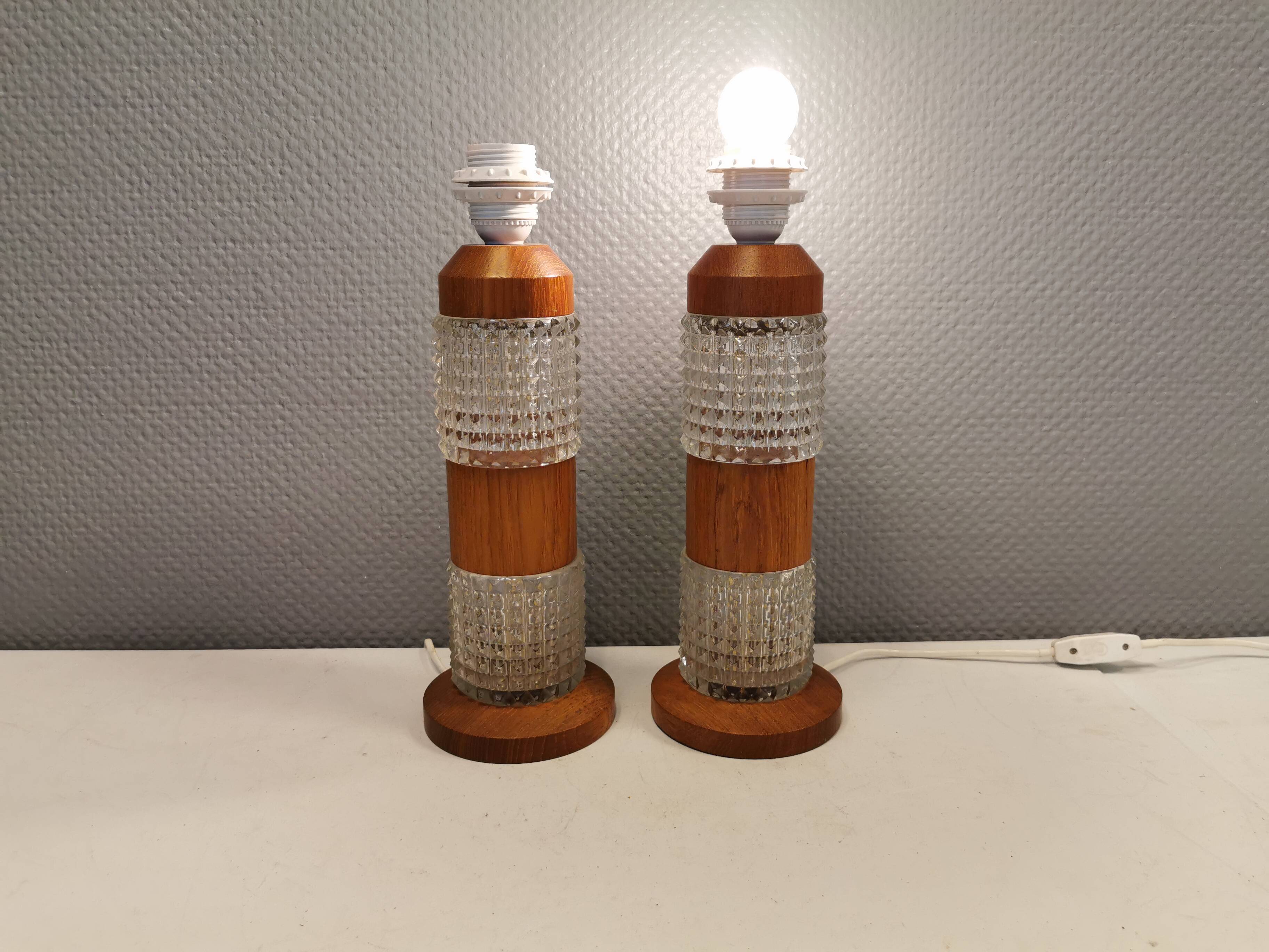 Swedish table lamps made of teak wood and hard pressed crystal glass.