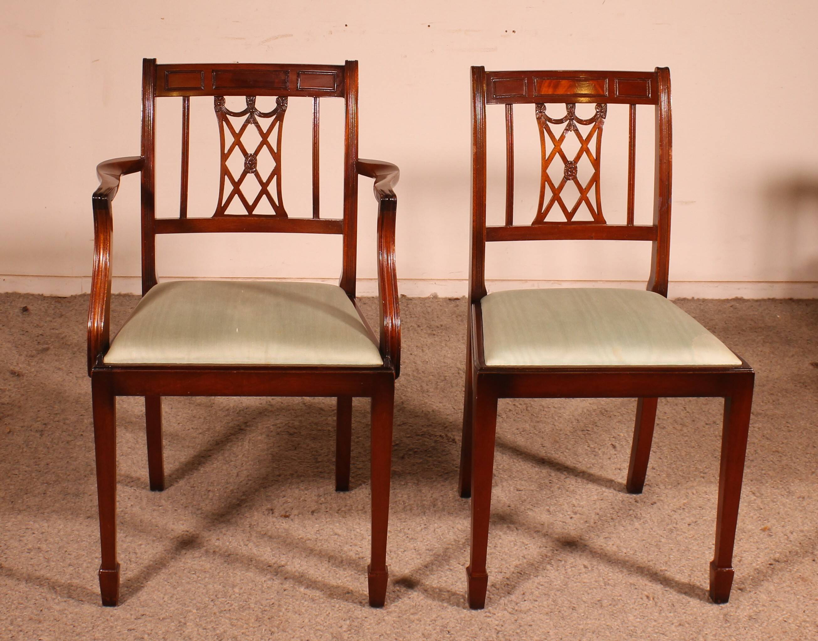 set of 10 chairs and two mahogany armchairs in Hepplewhite style