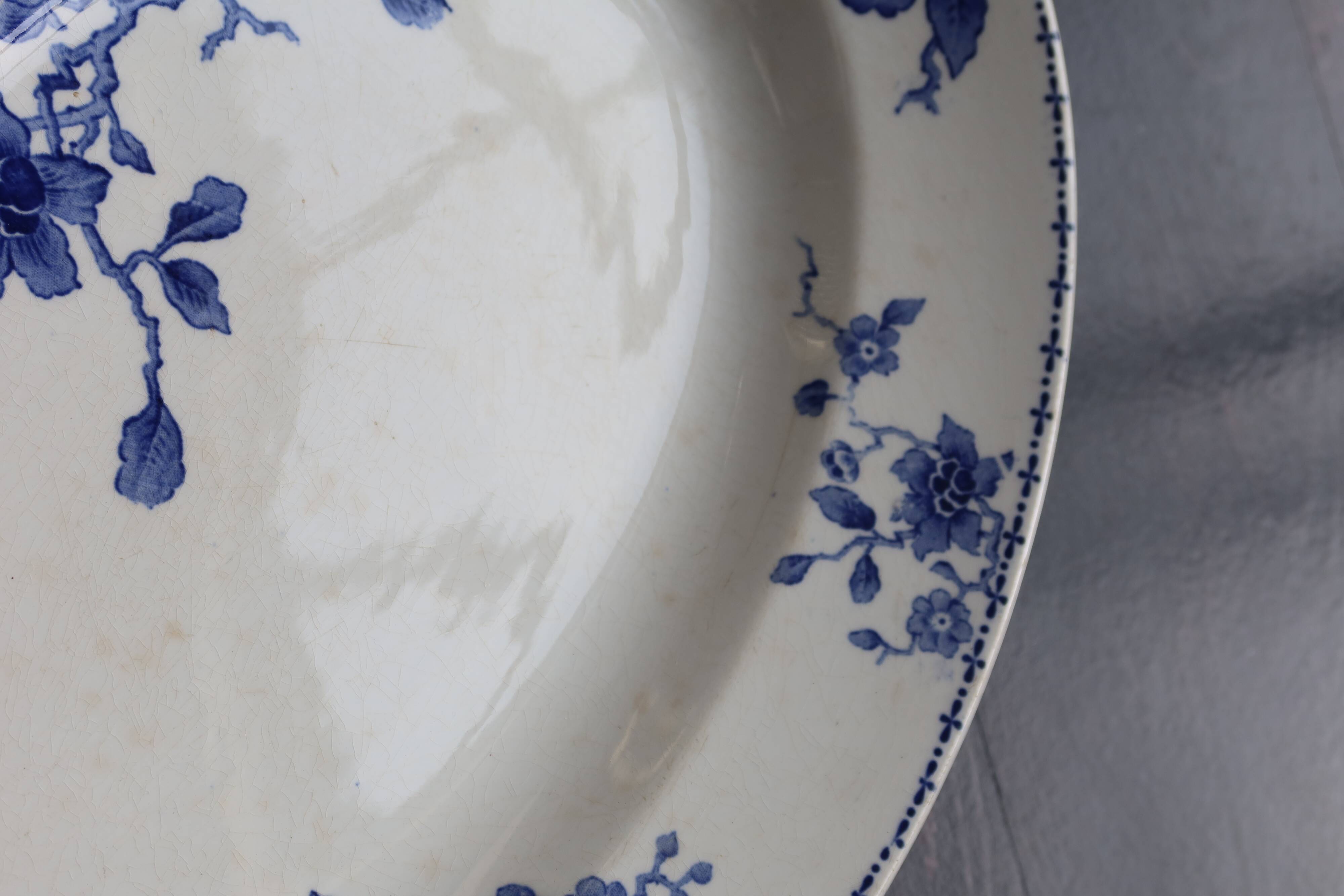 Antique serving dish in white and blue earthenware.