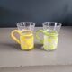 Pair of glass teacups with plastic handles