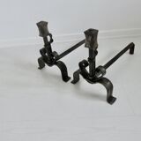Pair of ironwork andirons in the style of Raymond Subes, circa 1940