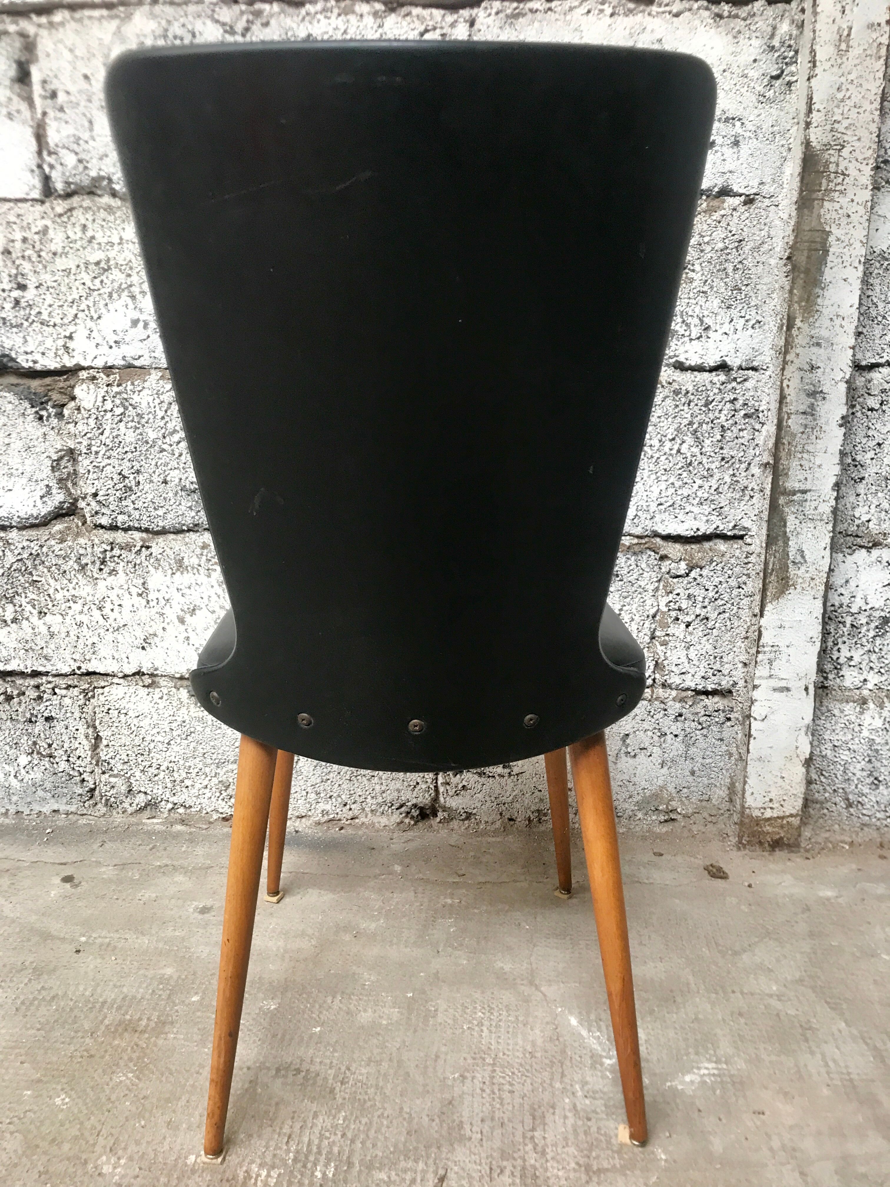 Pair of Baumann model Essor chairs in faux black leather, beech compass footing