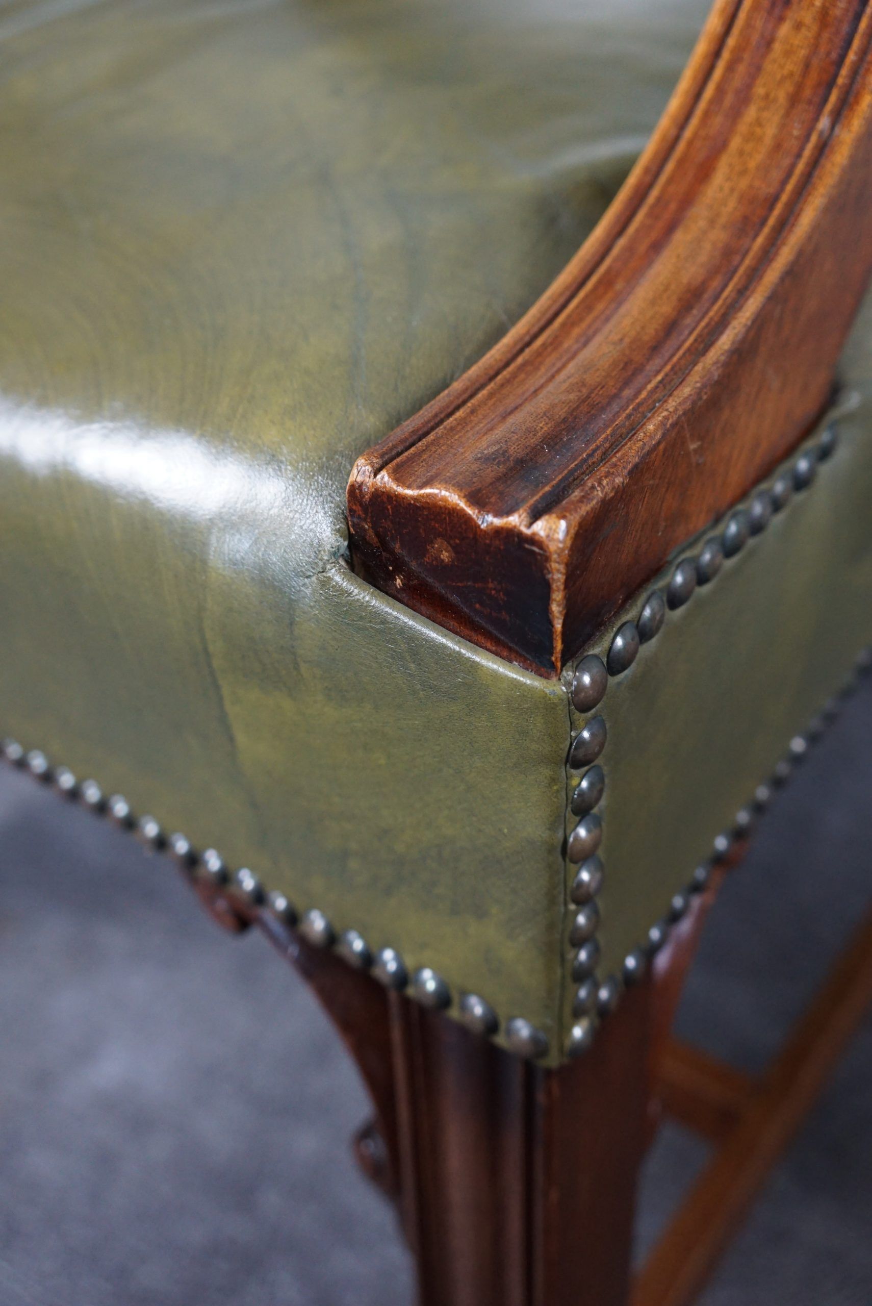 Elegant armchair and footrest in English green leather