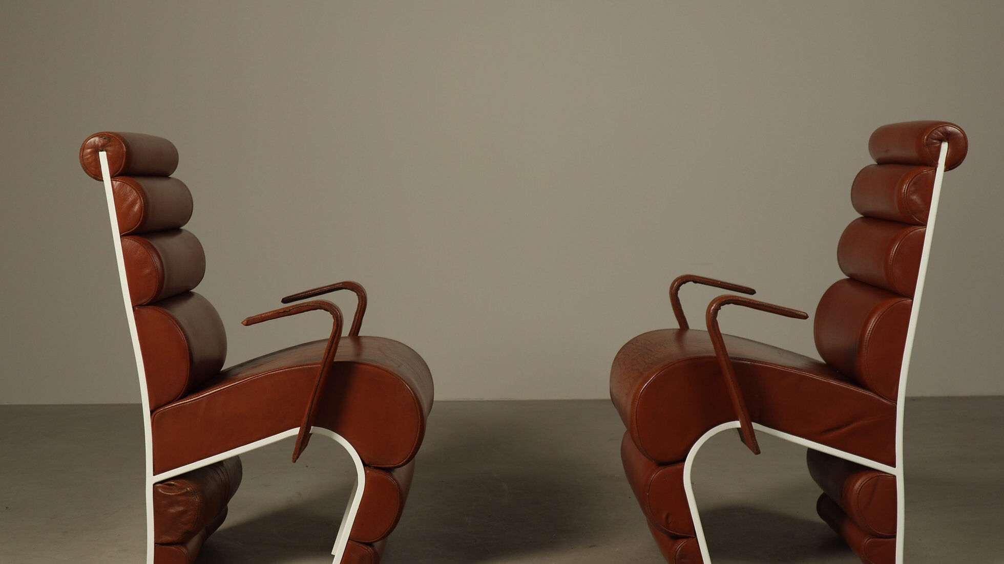 Pair of sculptural cognac leather armchairs, 1970s