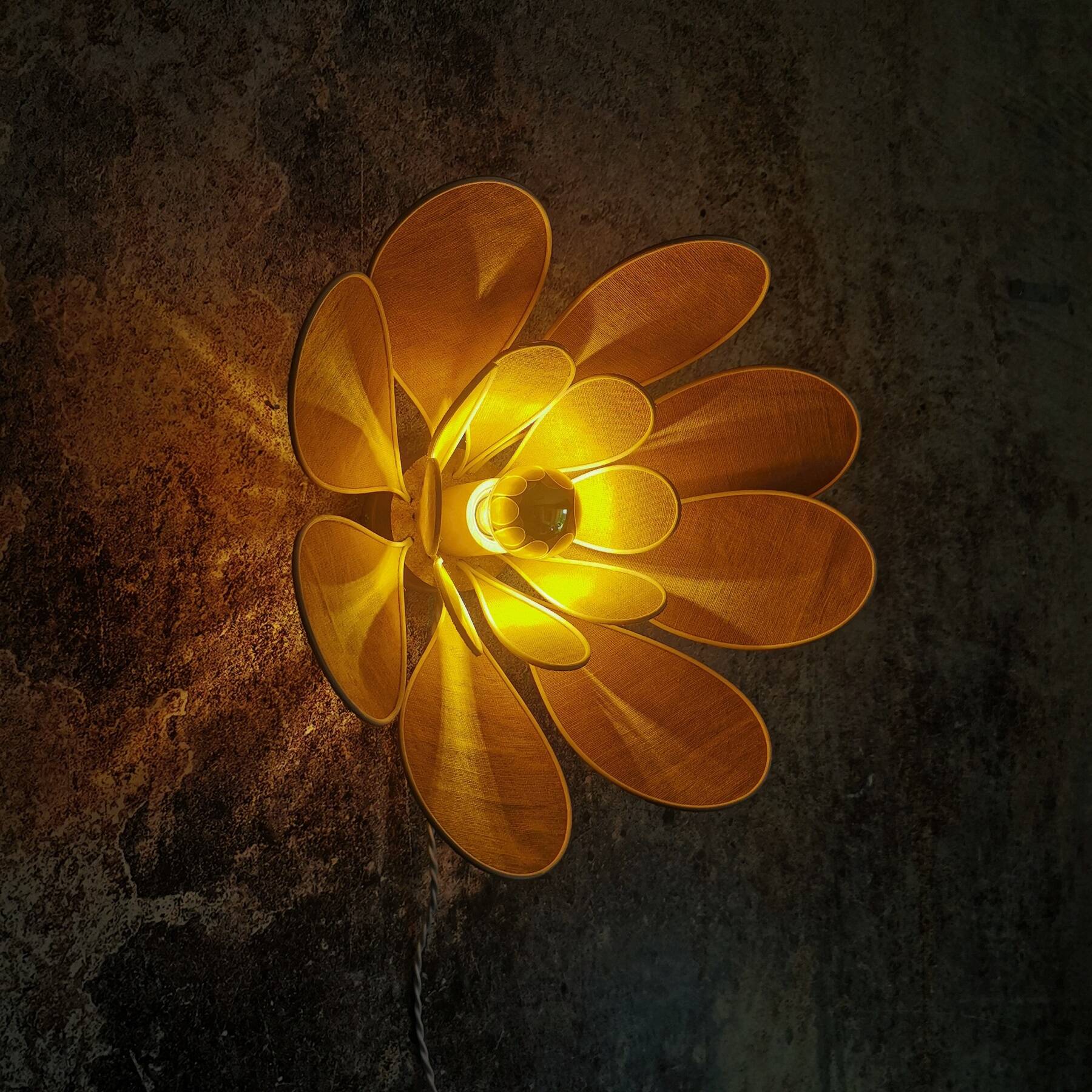Flower wall light made of rattan and saffron linen petals