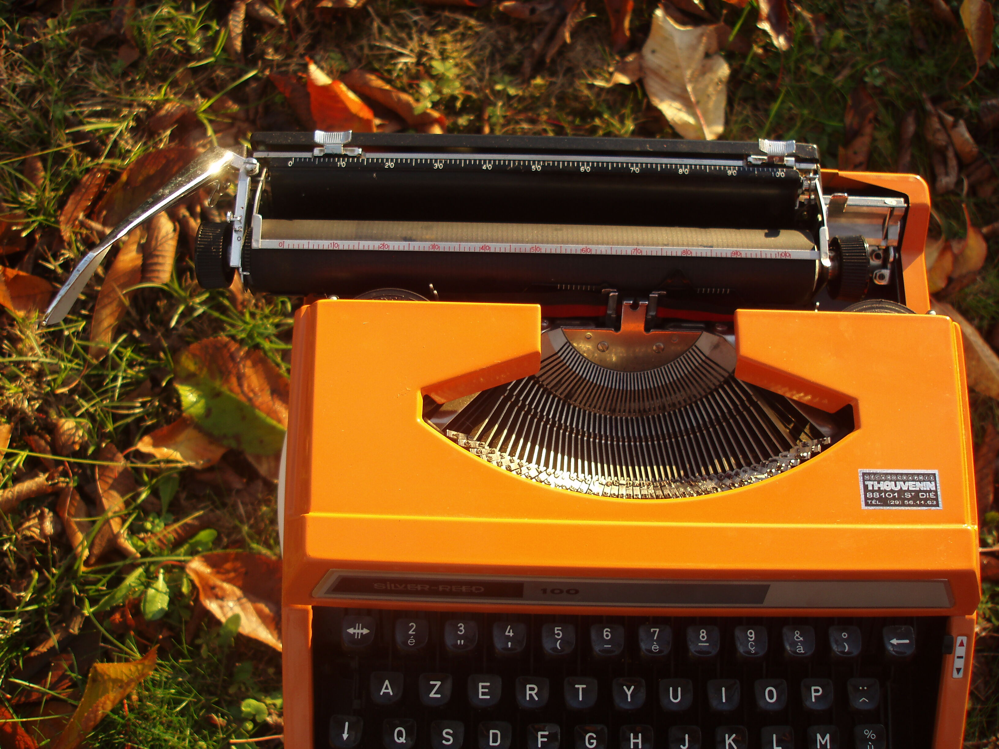 Silver reed orange and black typewriter with bag