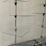 A pair of vintage side tables in glass and chrome metal.