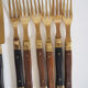 Set of old dessert cutlery in wood and brass