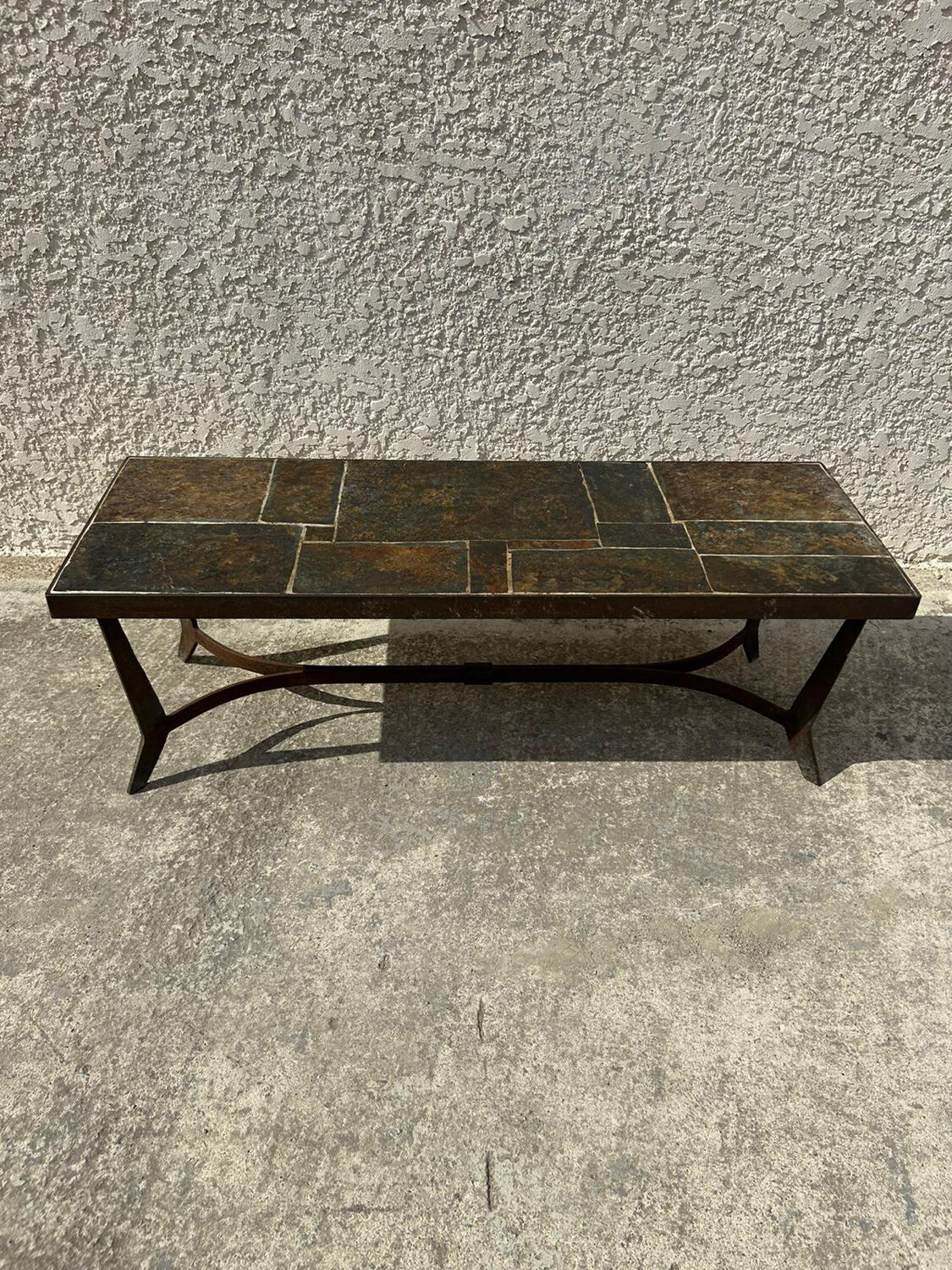 Coffee table with stone top and iron legs