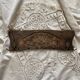 Wall-mounted coat rack in carved wood with rose decoration.
