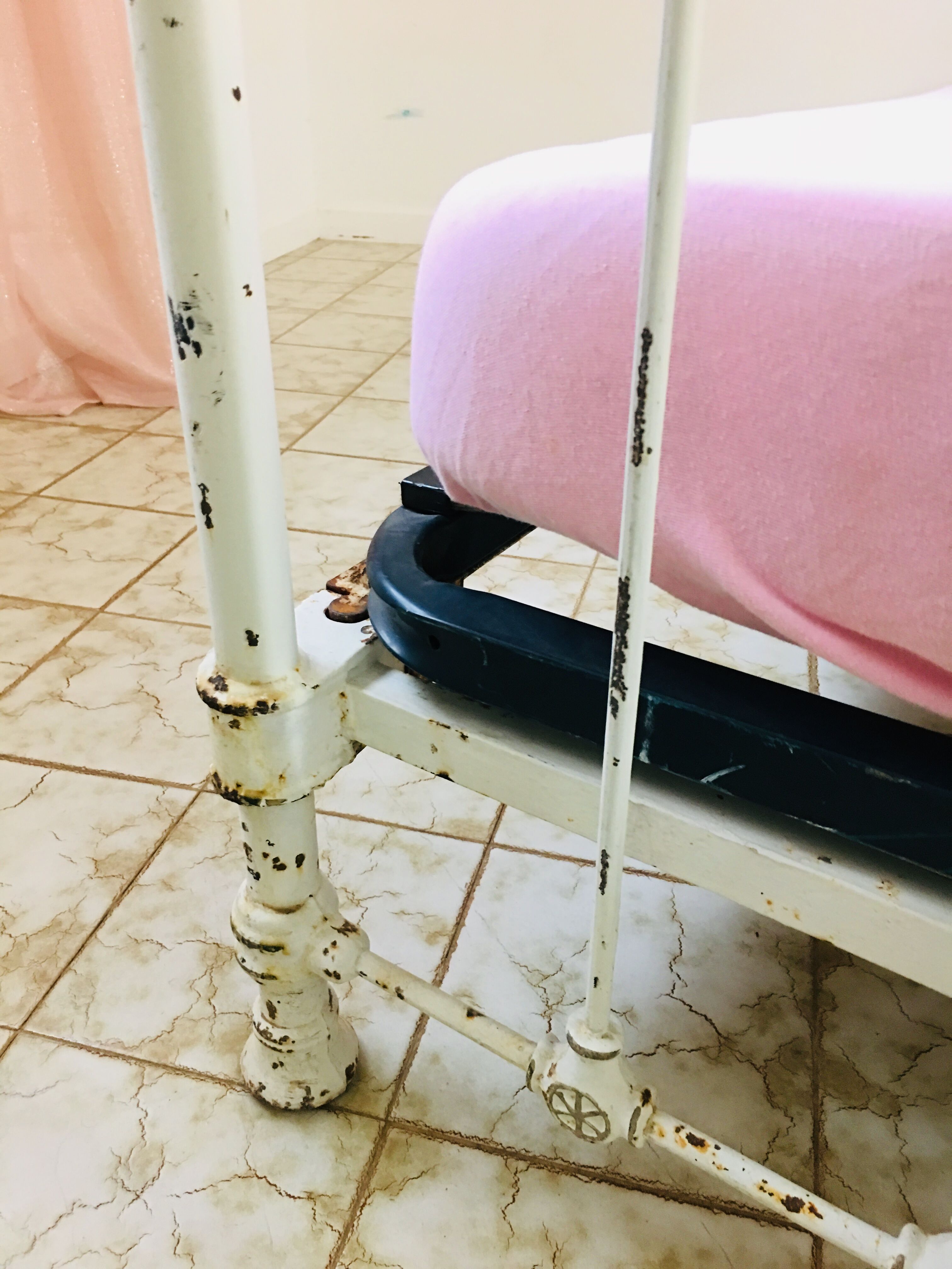 Old white metal and brass bed