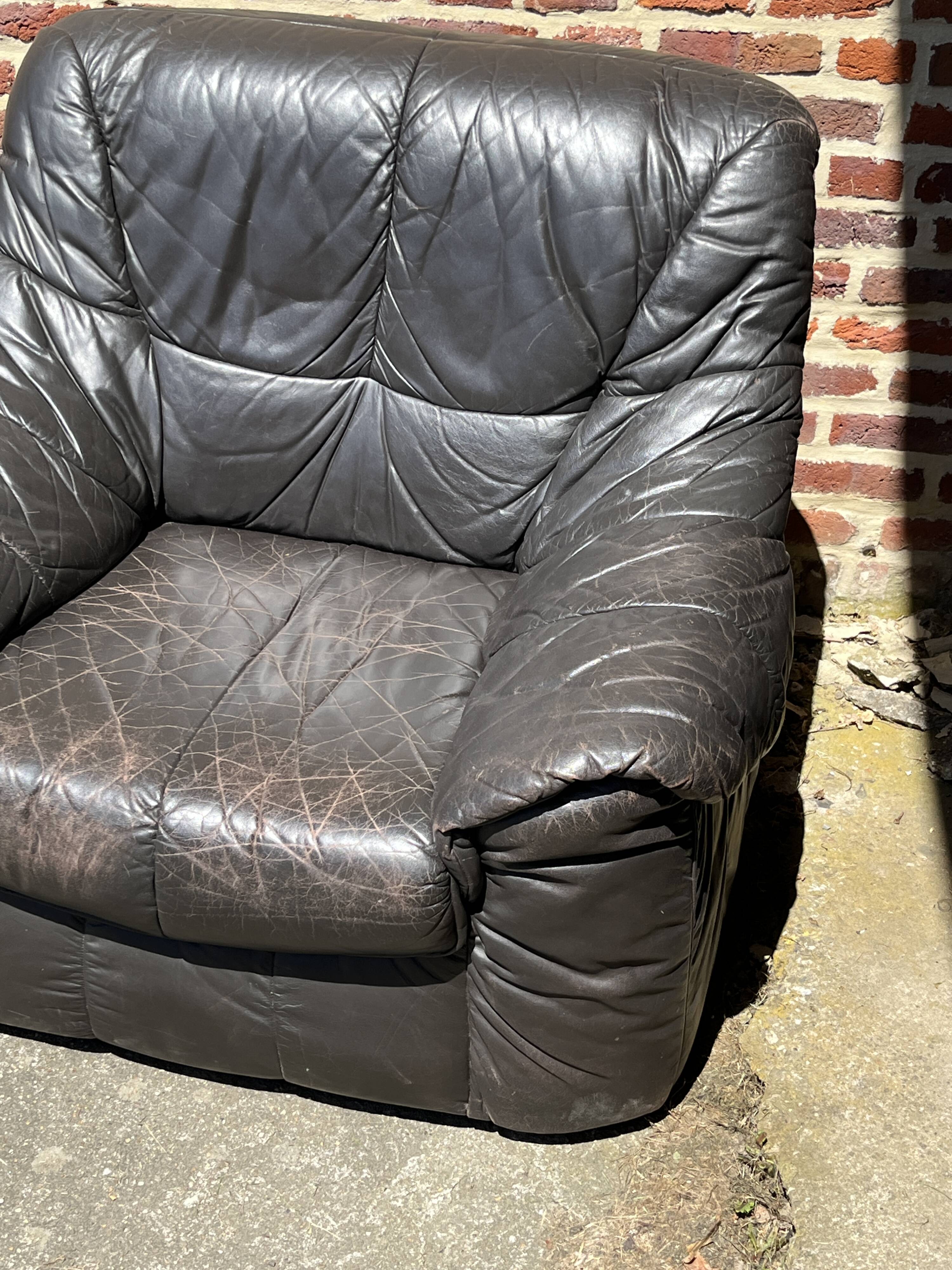 Pair of patinated leather club armchairs