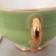 Coffee cup and under cup in green Salins earthenware and vintage gold net