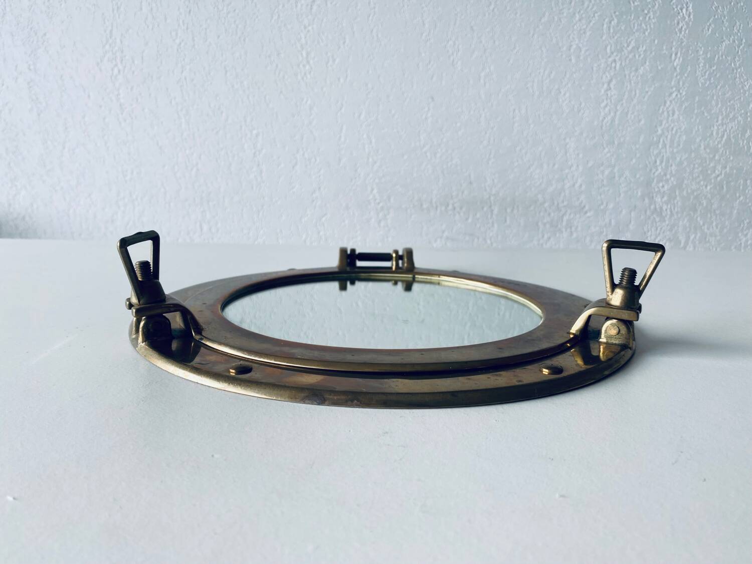 Porthole mirror in gilded brass