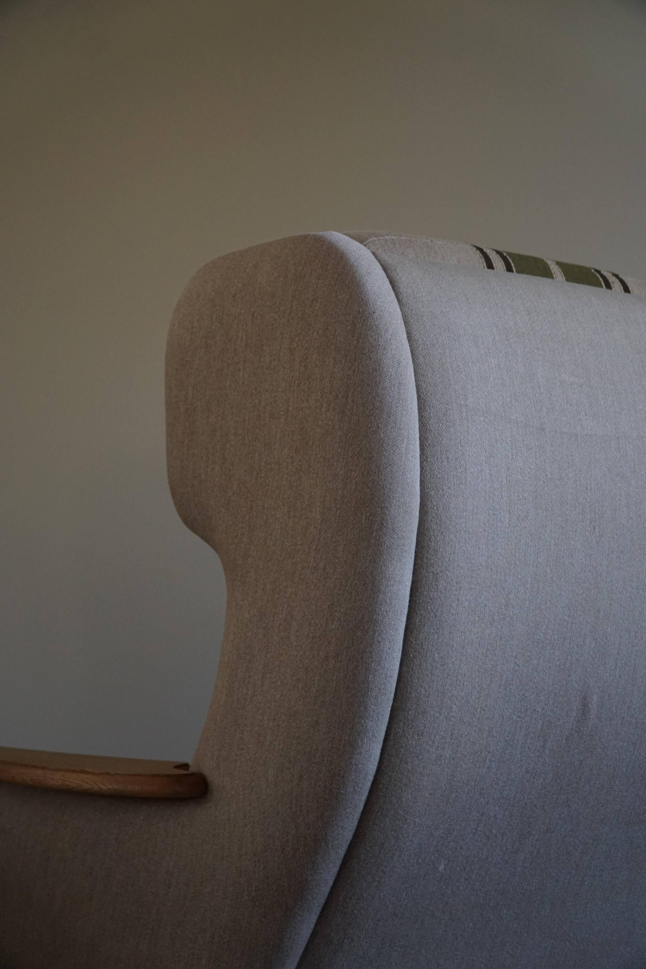 Pair of high-back lounge chairs in modern Danish style in the manner of Henning Kjærnulf, 1960s.