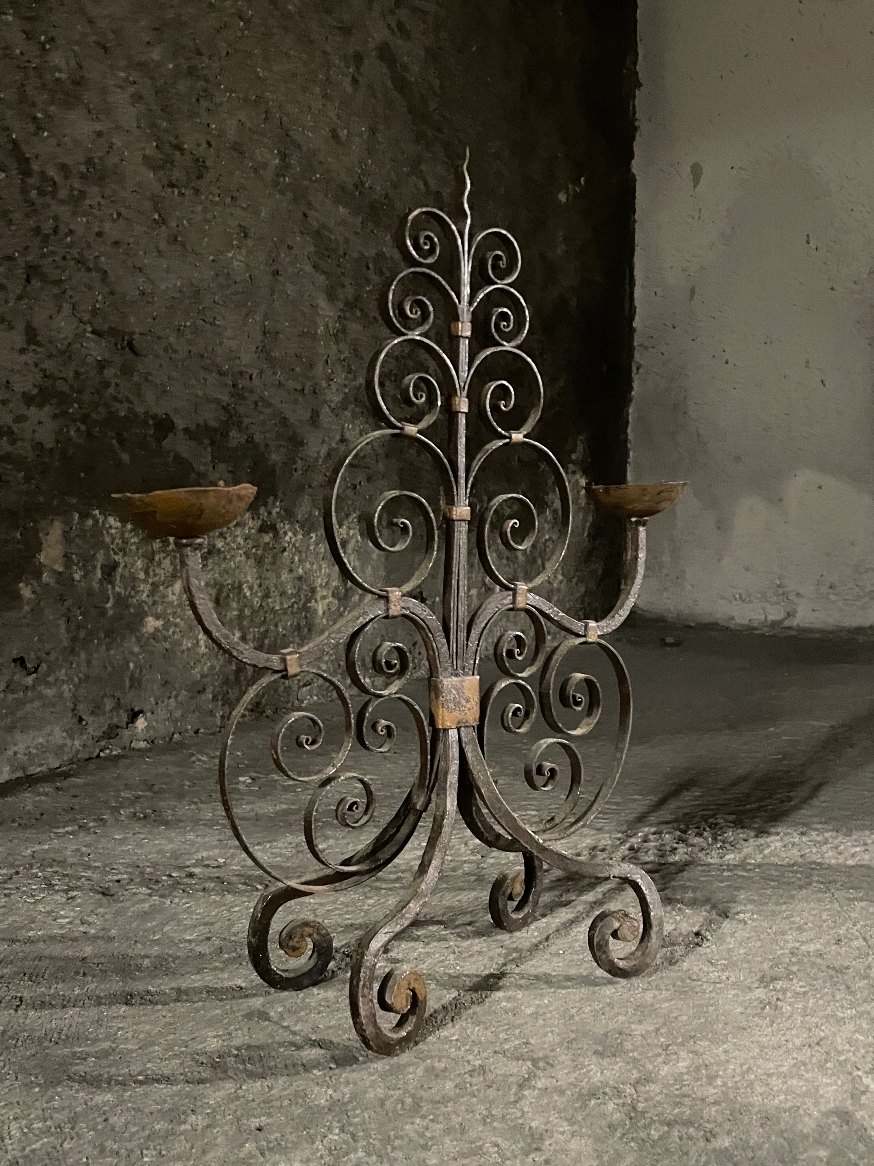 Pair of French wrought iron candelabra from the 19th century.