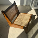 Reclined armchair in canned teak in natural wood