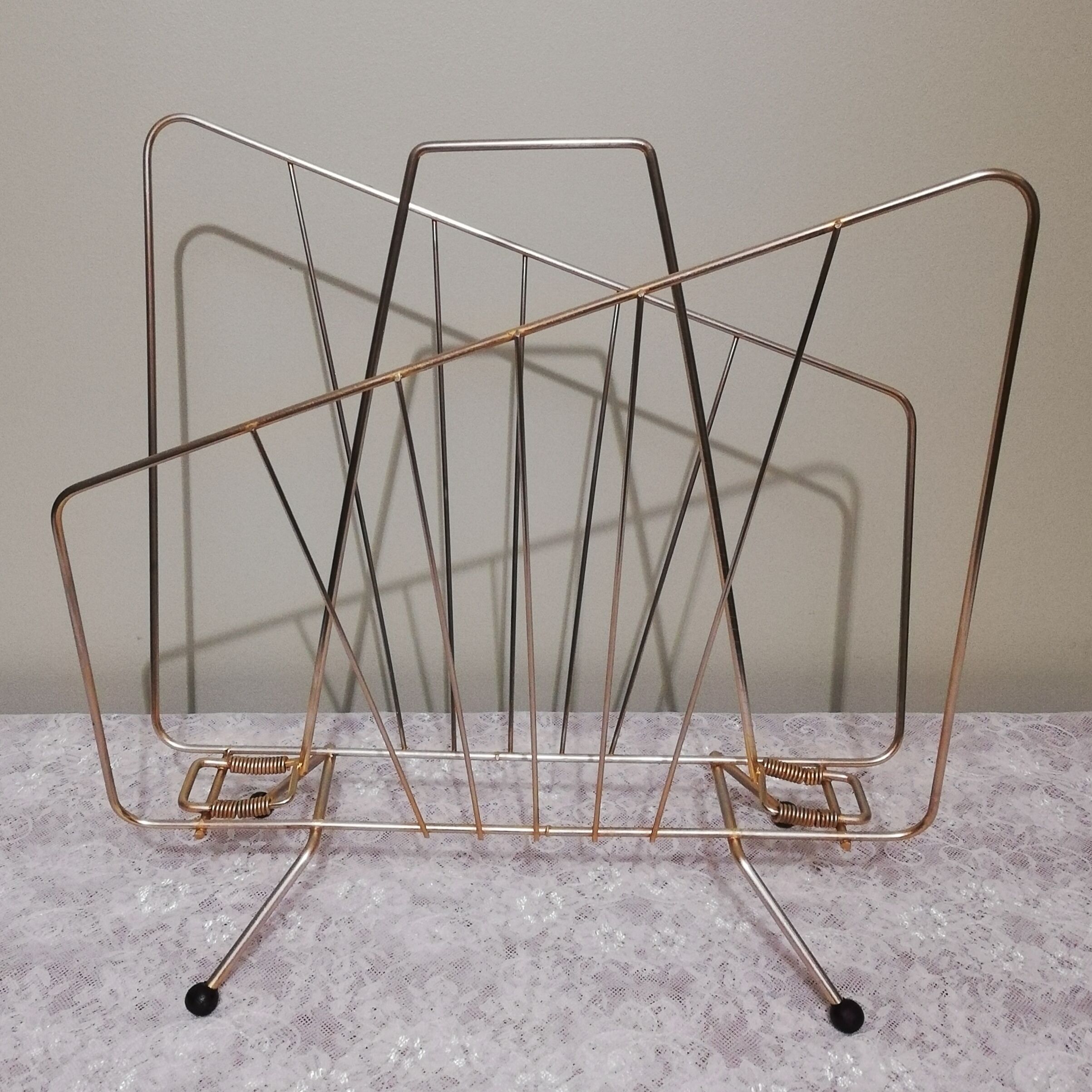 Vintage magazine holder in gilded brass.