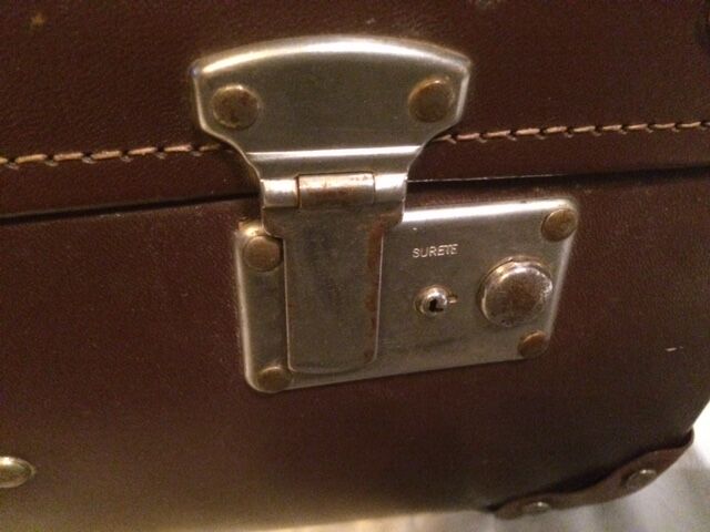 Suitcase vintage leather inside and brown carpeted home
