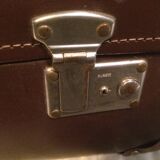 Suitcase vintage leather inside and brown carpeted home