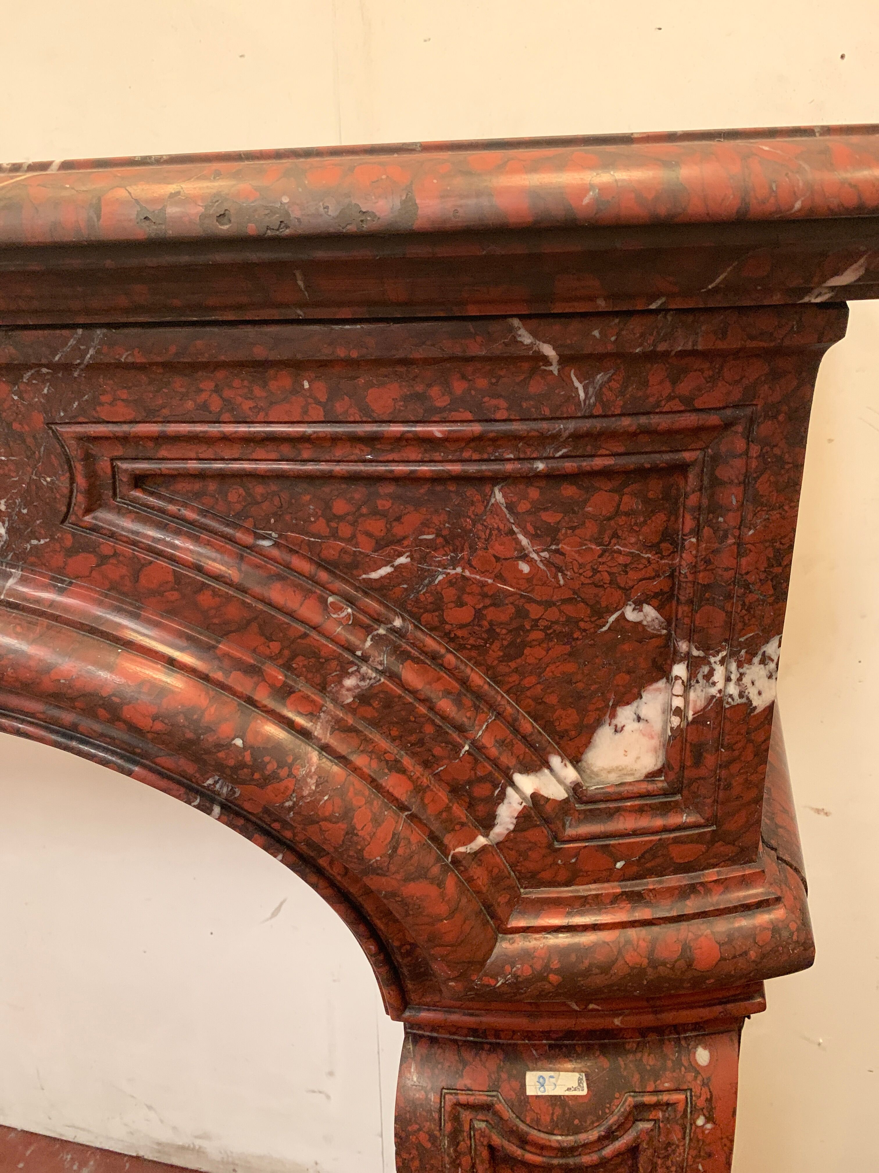 Pair of Louis XIV style fireplaces in red cherry marble. XIX century.