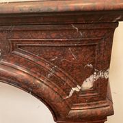 Pair of Louis XIV style fireplaces in red cherry marble. XIX century.