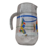 Vintage jug carafe for lemonade and juice, boats by the seaside, France.