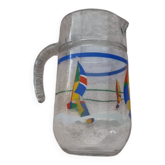 Vintage jug carafe for lemonade and juice, boats by the seaside, France.