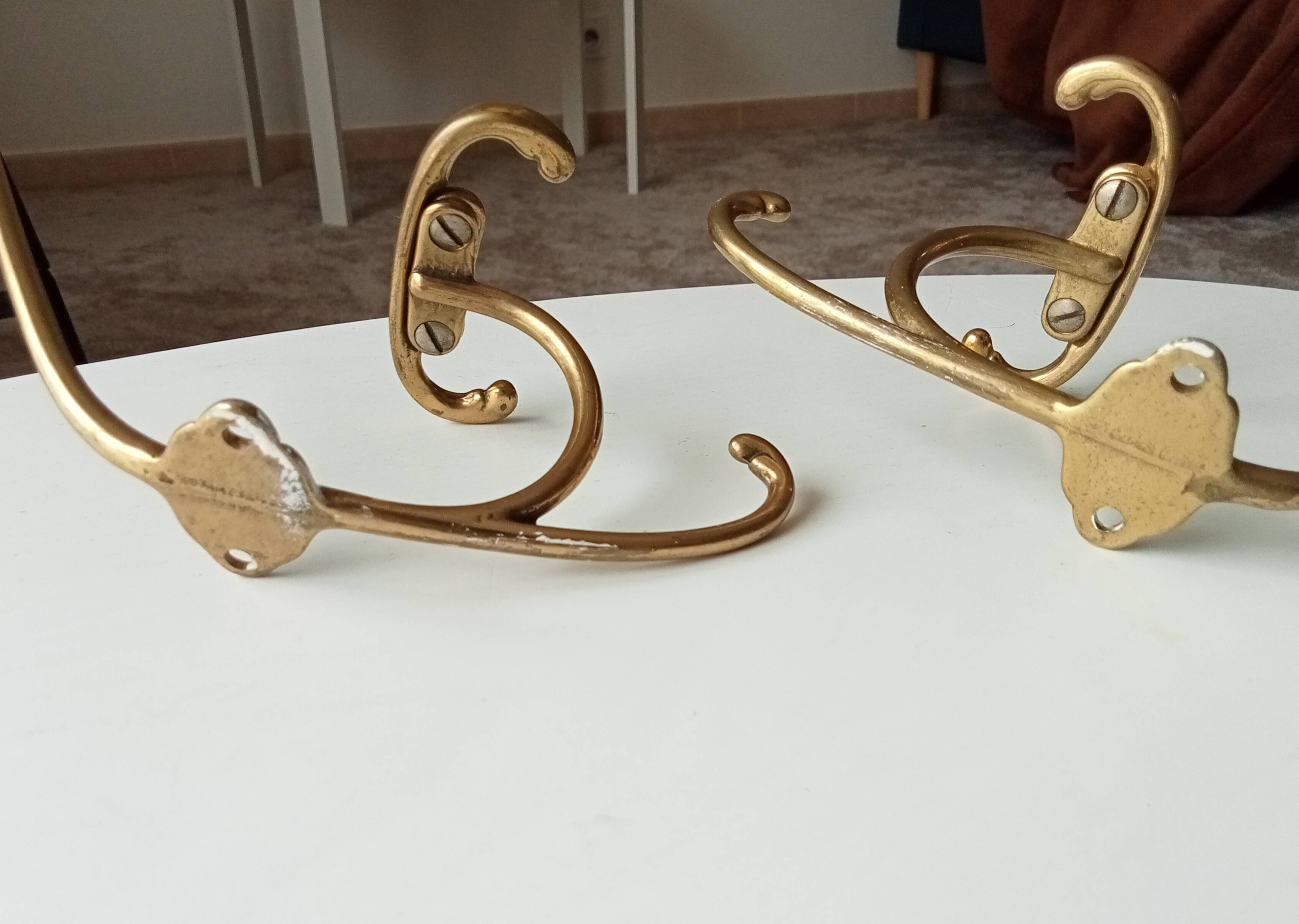 Old coat hook in solid golden brass