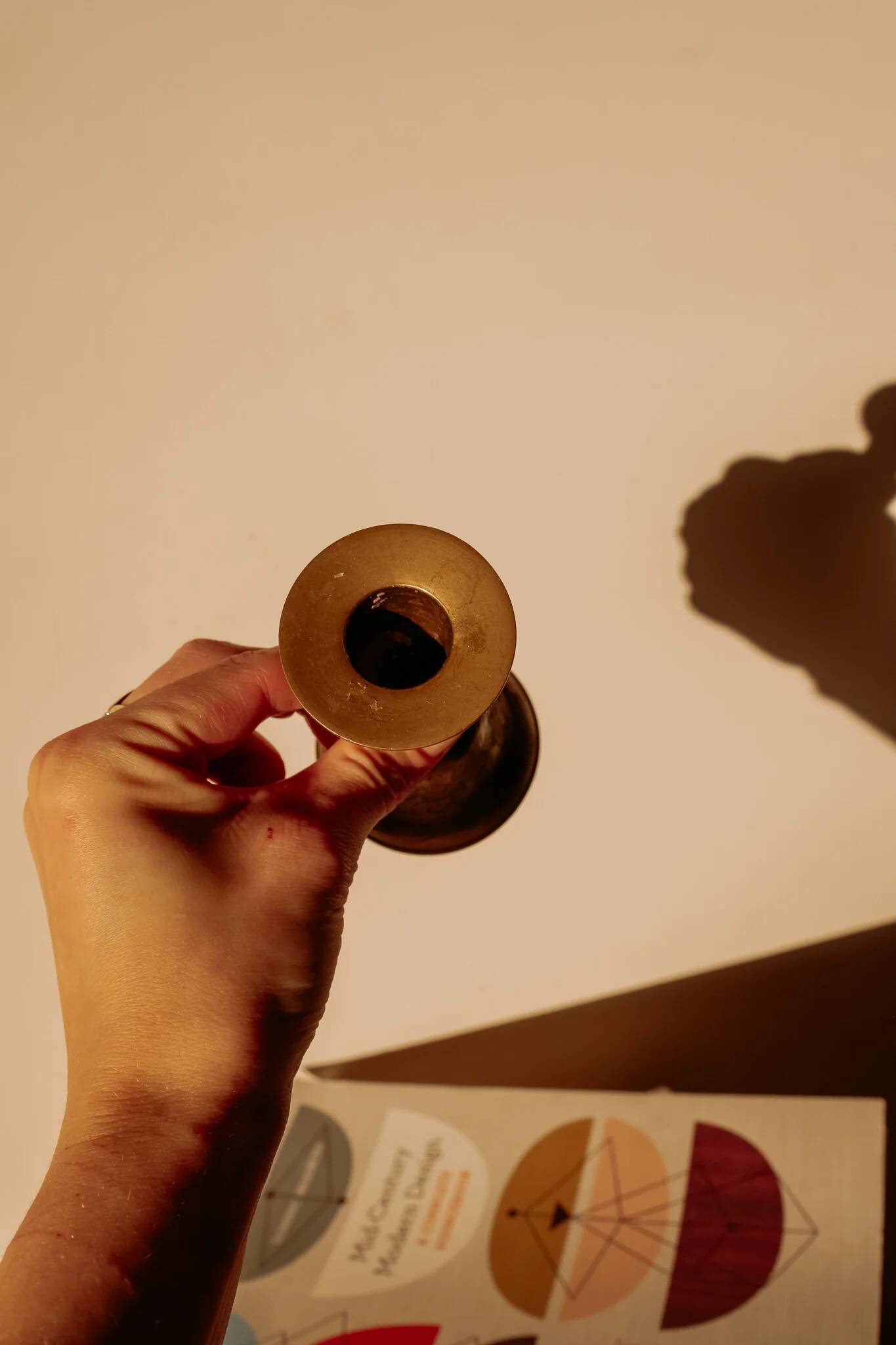 Brass candlestick in the shape of a bell.
