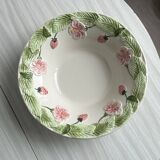 Ceramic slip dish with strawberry and flower pattern.