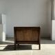 Small low armchair in varnished brown wood