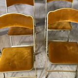 Four folding velvet and brass chairs