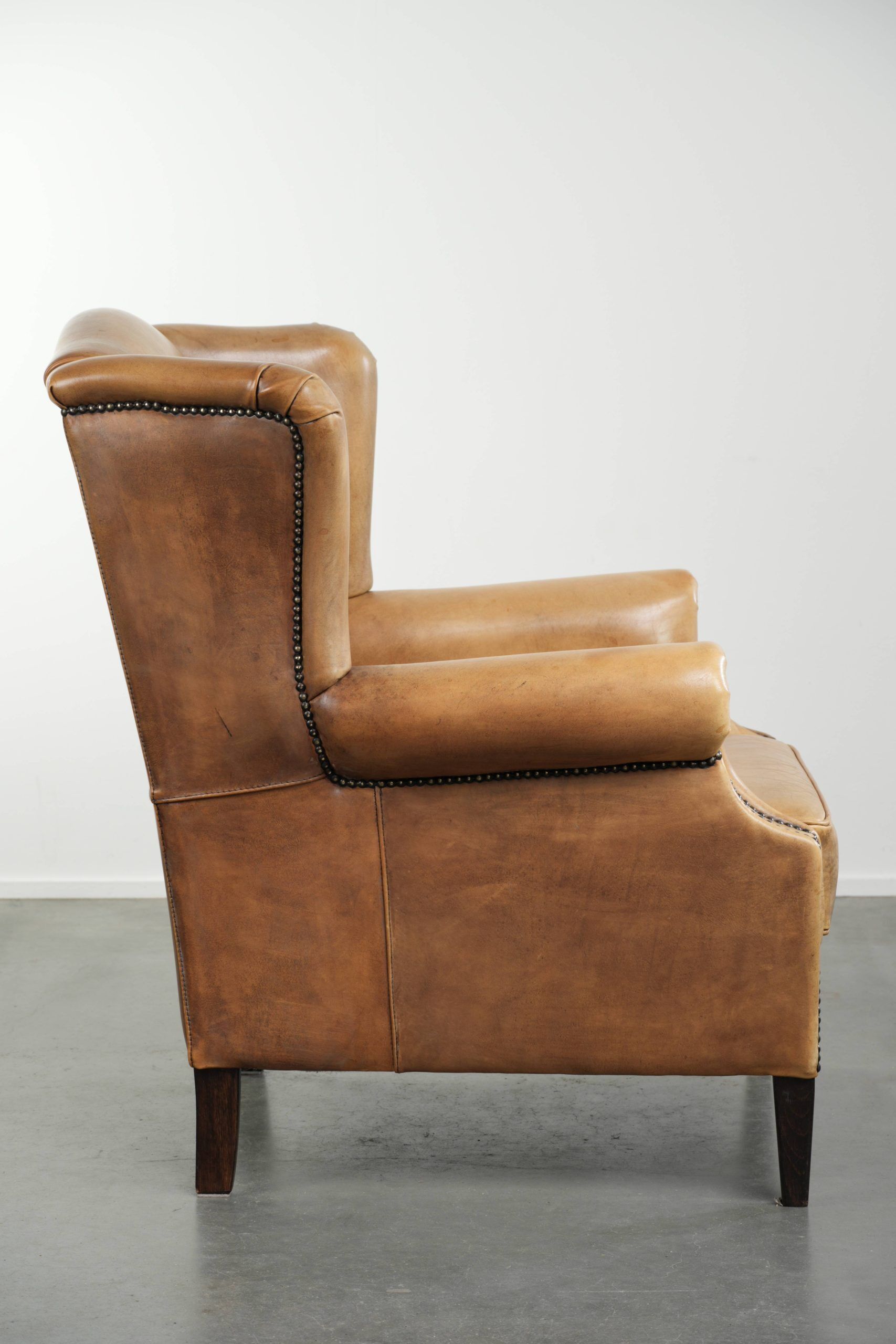 Comfortable cowhide wingback armchair with a timeless English look