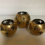 Trio of brass fleur-de-lis candle holders