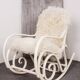 Antique Thonet rocking chair in ivory lacquered bent wood, with a white lamb fur seat.