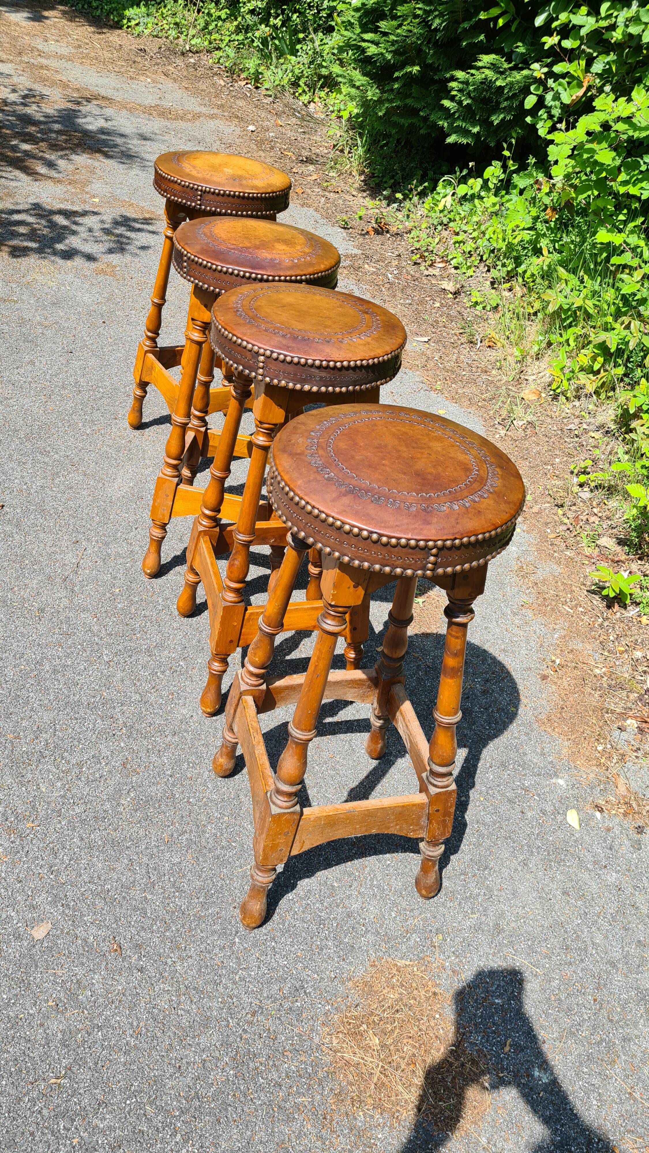 4 old leather and wood stools