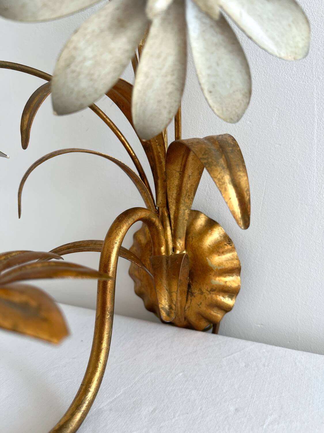 Vintage Hollywood Regency gold metal leaf wall sconce.