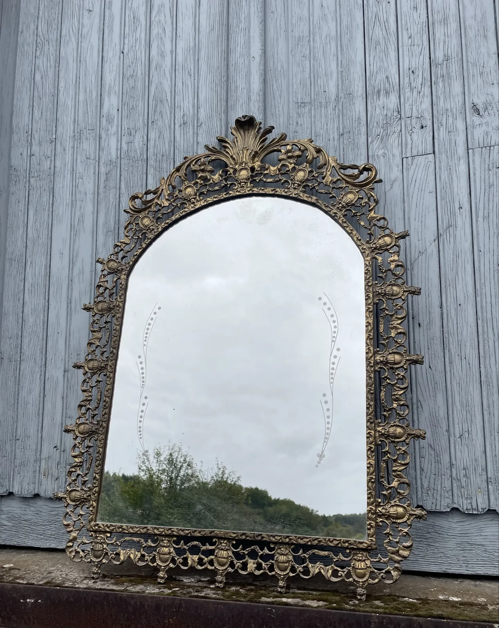 Vintage brass wall mirror adorned