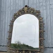 Vintage brass wall mirror adorned